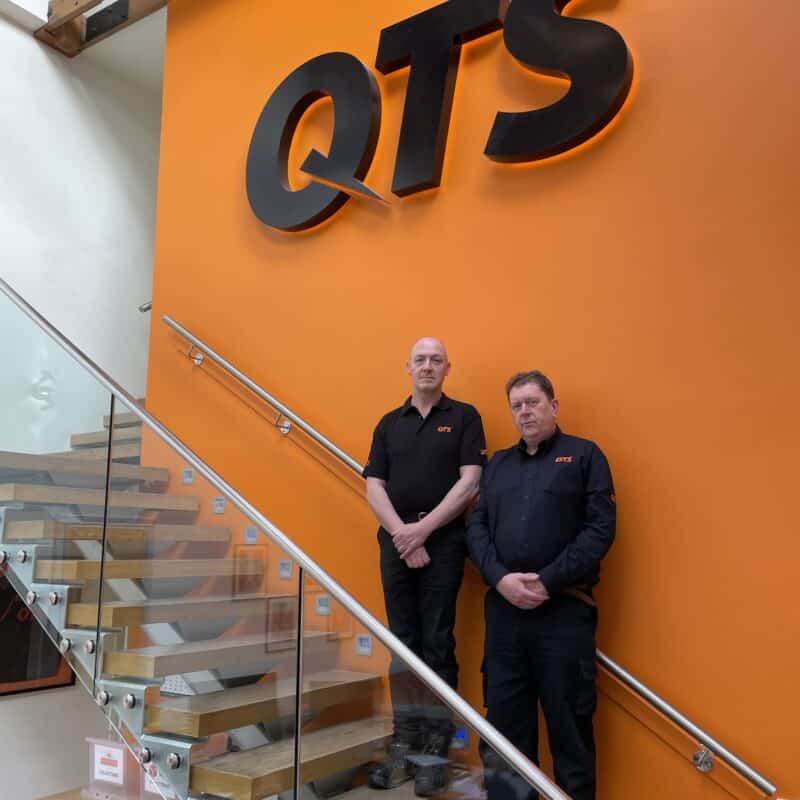 Allan and Aidan stand in the reception of the QTS HQ.