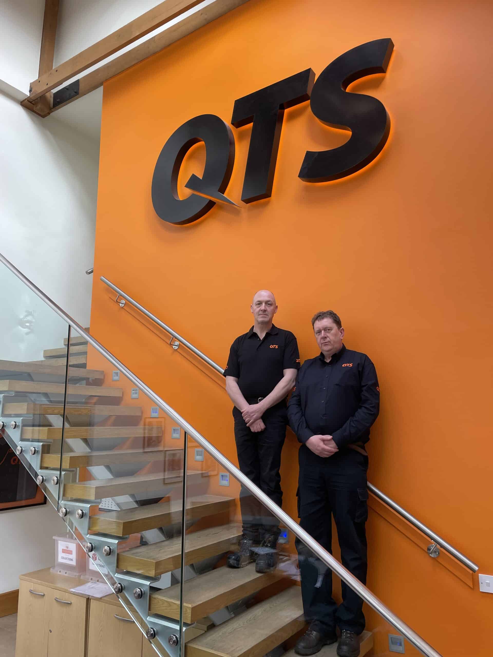 Allan and Aidan stand in the reception of the QTS HQ.